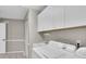 Laundry room featuring white cabinets, a sink, washer, and dryer at 7472 Clearmeadow Dr, Spring Hill, FL 34606