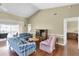 Bright living room featuring vaulted ceilings, wood floors, and a comfortable seating area at 7472 Clearmeadow Dr, Spring Hill, FL 34606