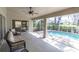 Enjoy the outdoors on this screened patio with ceiling fan and view of the pool at 7472 Clearmeadow Dr, Spring Hill, FL 34606