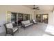 Covered patio with comfortable seating, offering views of the pool, dining area, and living room at 7472 Clearmeadow Dr, Spring Hill, FL 34606