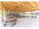 Large outdoor pavilion with picnic tables, ceiling fans, and exposed wooden beams at 7472 Clearmeadow Dr, Spring Hill, FL 34606