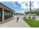 Inviting community pool area with ample seating, umbrellas, and screened dining area at 7472 Clearmeadow Dr, Spring Hill, FL 34606