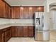 Kitchen featuring stainless steel refrigerator and granite countertops at 7603 S Kissimmee St, Tampa, FL 33616