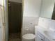 Bathroom with a shower, toilet, and vanity, designed with white and dark brown tiling at 9741 Scenic Dr, Port Richey, FL 34668