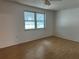 Bright bedroom with hardwood floors and a double window allowing natural light at 9741 Scenic Dr, Port Richey, FL 34668