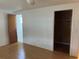 Cozy bedroom featuring hardwood floors, a closet, and an adjacent bathroom at 9741 Scenic Dr, Port Richey, FL 34668