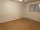 Empty bedroom showcasing hardwood floors and window at 9741 Scenic Dr, Port Richey, FL 34668