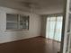 An empty bedroom featuring hardwood floors, white walls, and natural lighting at 9741 Scenic Dr, Port Richey, FL 34668