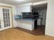 Kitchen with blue countertops, white cabinets, and a breakfast bar at 9741 Scenic Dr, Port Richey, FL 34668
