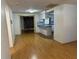 The living room features wood floors and a view into the kitchen area with white cabinets at 9741 Scenic Dr, Port Richey, FL 34668