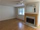 Living room with a fireplace and hardwood floors. A window provides natural light at 9741 Scenic Dr, Port Richey, FL 34668