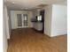 Open floor plan featuring hardwood floors and view into the kitchen at 9741 Scenic Dr, Port Richey, FL 34668