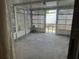 Enclosed sunroom with lattice walls and concrete floor at 9741 Scenic Dr, Port Richey, FL 34668