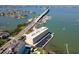 Aerial view of a waterfront apartment building complex near the bridge with parking and docks at 100 Bluff View Dr # 409C, Belleair Bluffs, FL 33770