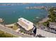 Aerial view of a waterfront apartment building with boat docks, parking and a view of the bay at 100 Bluff View Dr # 409C, Belleair Bluffs, FL 33770