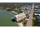 A high angle shot exhibits the layout of the building, adjacent streets, and nearby waterfront at 100 Bluff View Dr # 409C, Belleair Bluffs, FL 33770