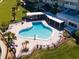 Aerial view of a community pool with lounge chairs and well-manicured landscaping at 100 Bluff View Dr # 409C, Belleair Bluffs, FL 33770