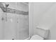 Bright bathroom with white tiled walk-in shower and mosaic accents at 100 Bluff View Dr # 409C, Belleair Bluffs, FL 33770