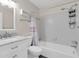 White bathroom featuring a shower and tub with a marble vanity and modern fixtures at 100 Bluff View Dr # 409C, Belleair Bluffs, FL 33770