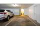 Garage space with car parked inside and door leading into the home at 100 Bluff View Dr # 409C, Belleair Bluffs, FL 33770
