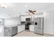 Updated kitchen with stainless steel appliances, white cabinetry, and a stylish backsplash at 100 Bluff View Dr # 409C, Belleair Bluffs, FL 33770