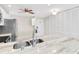 Bright kitchen with a stainless steel sink, modern faucet, and granite countertops at 100 Bluff View Dr # 409C, Belleair Bluffs, FL 33770