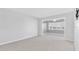 Cozy living room with an opening into a room with windows at 100 Bluff View Dr # 409C, Belleair Bluffs, FL 33770