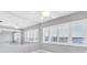 Bright living room with bright windows offering a peek of the water view and tiled floors at 100 Bluff View Dr # 409C, Belleair Bluffs, FL 33770