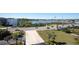 View of the street near the condos, showing the American flag, road and nearby water at 100 Bluff View Dr # 409C, Belleair Bluffs, FL 33770