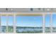 Waterfront view through large windows overlooking serene bay and surrounding community at 100 Bluff View Dr # 409C, Belleair Bluffs, FL 33770