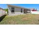 Backyard with a white fence, tropical landscaping, and screened-in patio at 11009 Silver Dancer Dr, Riverview, FL 33579