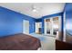 Bedroom with blue walls, ceiling fan, and carpet at 11009 Silver Dancer Dr, Riverview, FL 33579