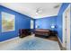Bright bedroom with blue walls, wood floors, and a ceiling fan at 11009 Silver Dancer Dr, Riverview, FL 33579