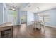 Open dining area featuring wood-look floors, modern lighting, and neutral wall paint at 11009 Silver Dancer Dr, Riverview, FL 33579