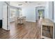 Open dining area featuring wood-look floors, modern lighting, and neutral wall paint at 11009 Silver Dancer Dr, Riverview, FL 33579