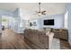 Open-concept living space featuring a large TV, modern furnishings, and stylish decor at 11009 Silver Dancer Dr, Riverview, FL 33579