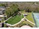 An aerial view of a well-maintained neighborhood playground and tennis court with lush landscaping and recreational amenities at 11009 Silver Dancer Dr, Riverview, FL 33579