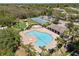 Aerial view of the community pool, clubhouse, and tennis courts at 11009 Silver Dancer Dr, Riverview, FL 33579