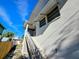 Staircase leading up to the home, adjacent to a fence with bright blue skies above at 11488 Short Ave, Largo, FL 33774