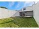 Backyard view showing screen enclosed patio and cinder block fence at 11918 Dietz Dr # 28, Tampa, FL 33626