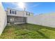 Backyard view showing screen enclosed patio and cinder block fence at 11918 Dietz Dr # 28, Tampa, FL 33626