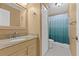 Bathroom showcasing a sink with granite countertop and a shower with blue curtain at 11918 Dietz Dr # 28, Tampa, FL 33626