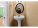 Cozy powder room featuring a pedestal sink and a modern mirror at 11918 Dietz Dr # 28, Tampa, FL 33626