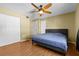 Bedroom with blue bed, ceiling fan, and wood-look floors at 11918 Dietz Dr # 28, Tampa, FL 33626