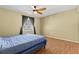 Bedroom with blue bed, ceiling fan, and wood-look floors at 11918 Dietz Dr # 28, Tampa, FL 33626