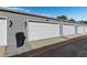View of three single car garages with white doors and gray siding at 11918 Dietz Dr # 28, Tampa, FL 33626