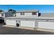 View of three single car garages with white doors and gray siding at 11918 Dietz Dr # 28, Tampa, FL 33626
