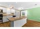 Open concept kitchen with center island, white cabinets and stainless steel appliances at 11918 Dietz Dr # 28, Tampa, FL 33626