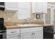 Kitchen sink with white cabinets and stainless steel appliances at 11918 Dietz Dr # 28, Tampa, FL 33626