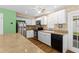 Charming kitchen with stainless steel appliances, white cabinets and tile backsplash at 11918 Dietz Dr # 28, Tampa, FL 33626
